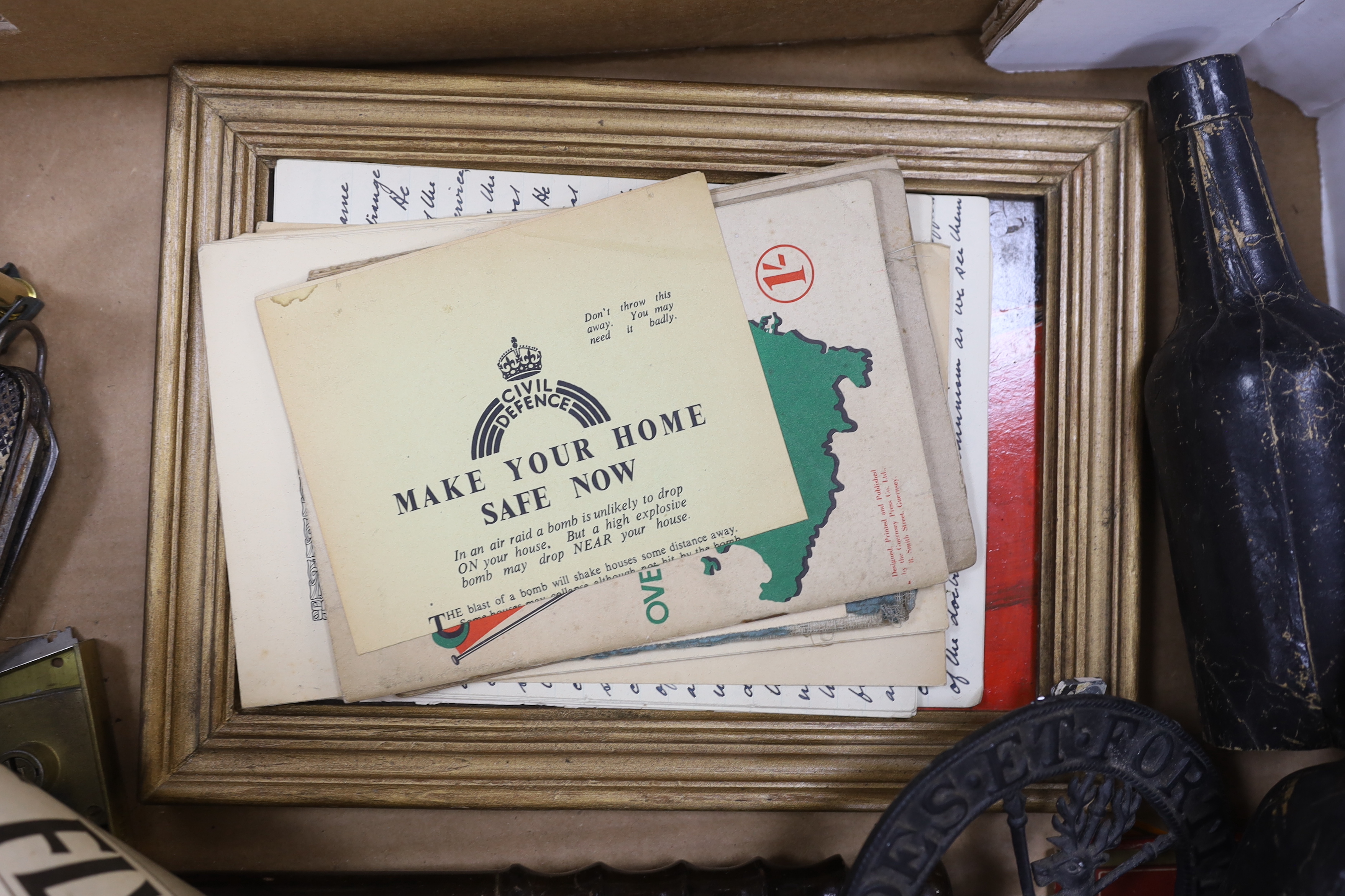 A collection of Militaria and other items, including a Royal Artillery brass cased timepiece, headphones, crepe paper bunting contained in a card Worthington’s IPA beer bottle, etc.